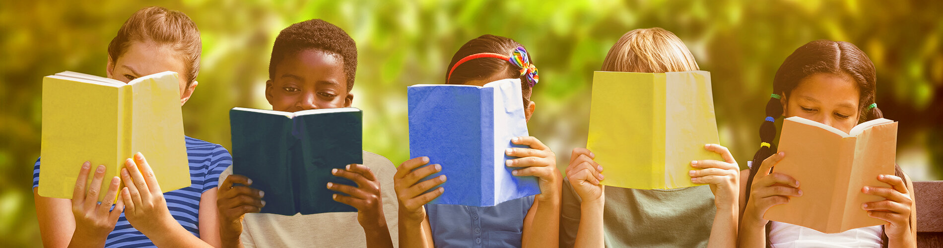 Group of children reading books outdoors.