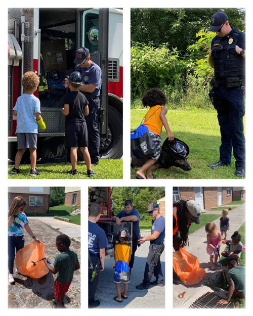 Children helping with trash clean up, along with other individuals such as Police officers.